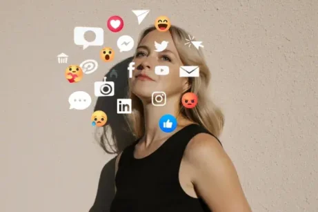 Žena stojí ve světle, kolem ní se vznášejí ikony sociálních sítí. Symbolika zahlcení online světem a hledání vnitřního klidu.